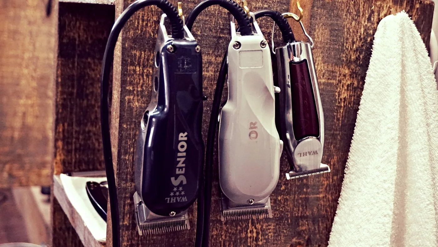 Wahl clippers on a rustic wood barber station